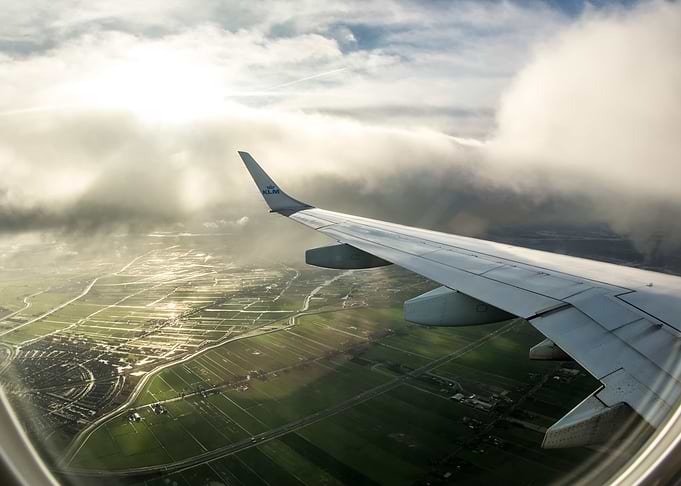 Wing view flying airplane