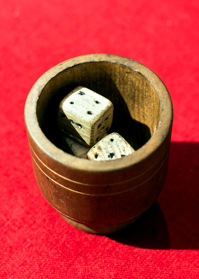 Bowl Of Dices On Red Table
