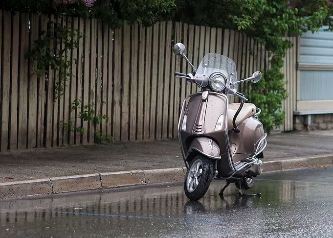 Scooter Parked In The Rain