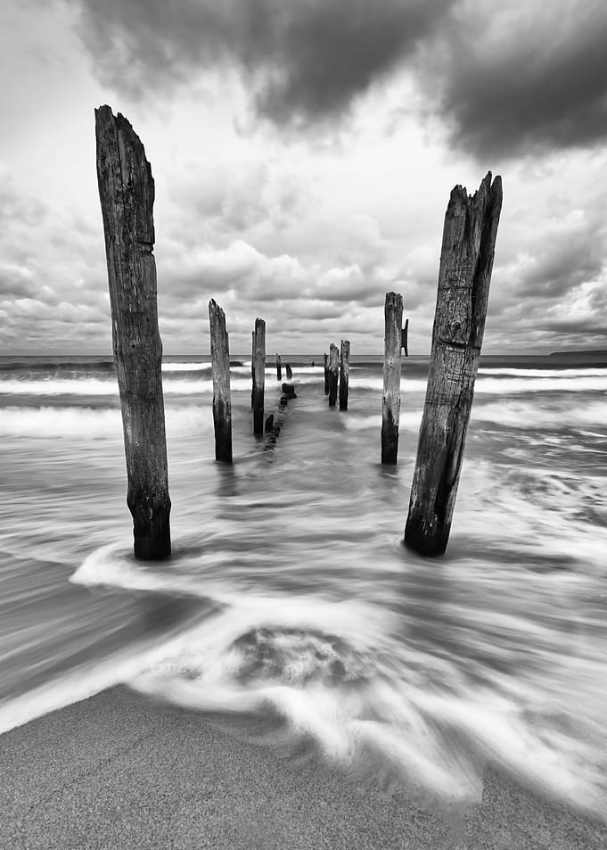 Wooden poles on the beach