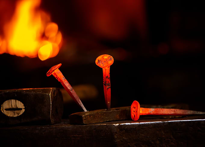 Hot metal nail on anvil