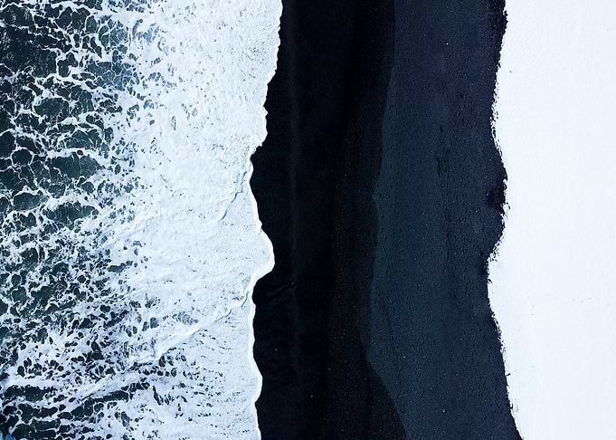 Black sand waves and snow