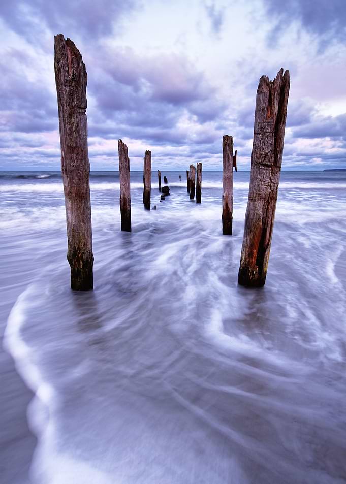 Wooden poles on the beach