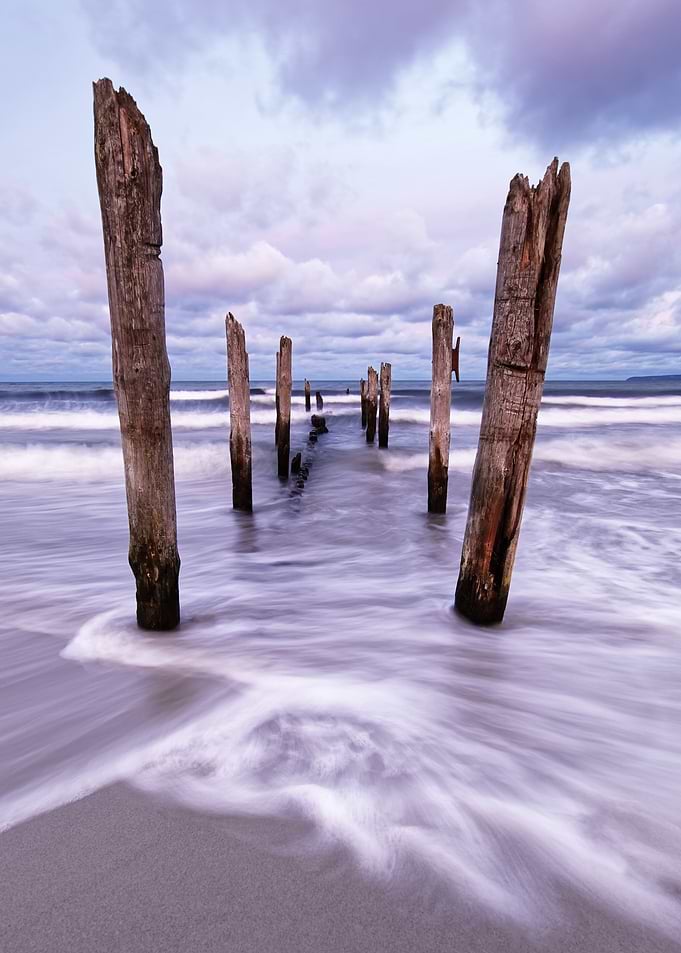 Wooden poles on the beach