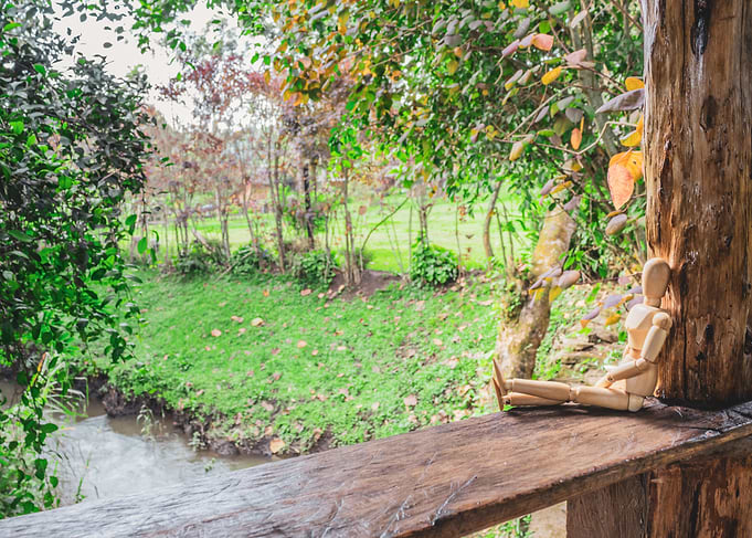 Wooden manikin sitting