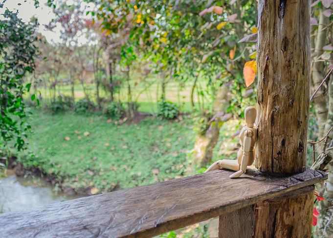 Wooden manikin sitting