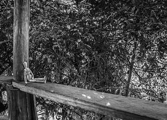 Wooden manikin sitting