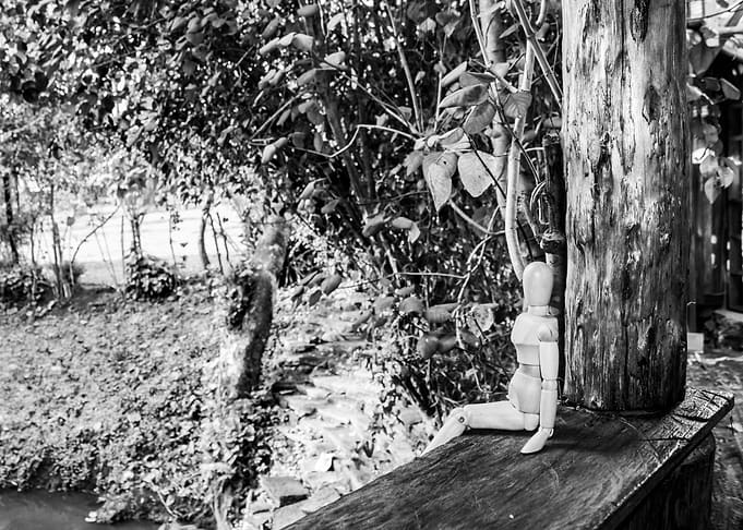Wooden manikin sitting