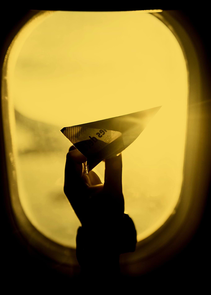 Paper airplane on window