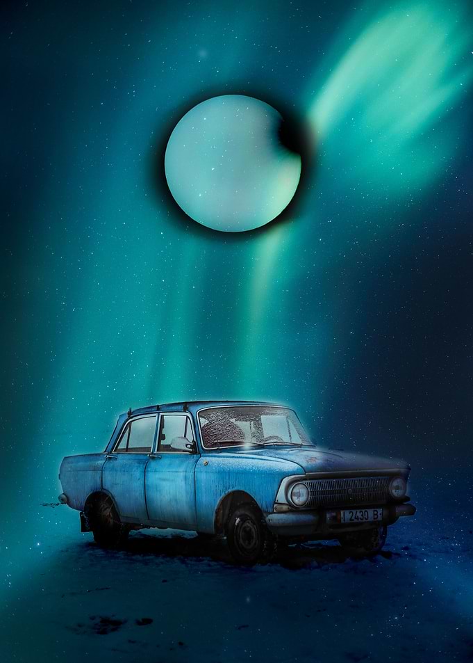 Car under northern lights