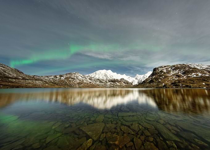 Northern lights over a mou