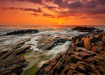 Sunset on lake sea rock