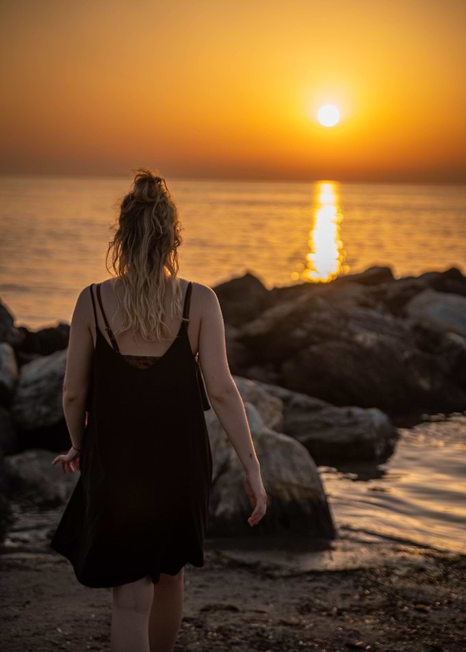 Girl at beach while sunset