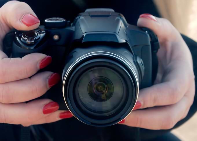 Camera woman holding photo