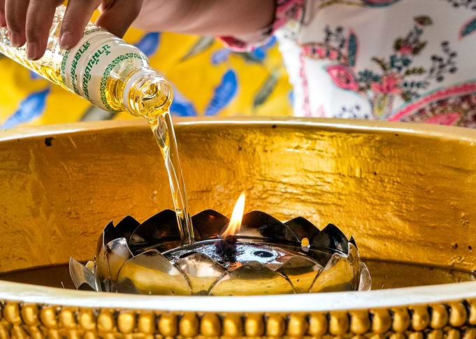 Woman lighting an oil cand