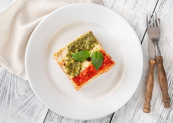 Portion of lasagne on whit