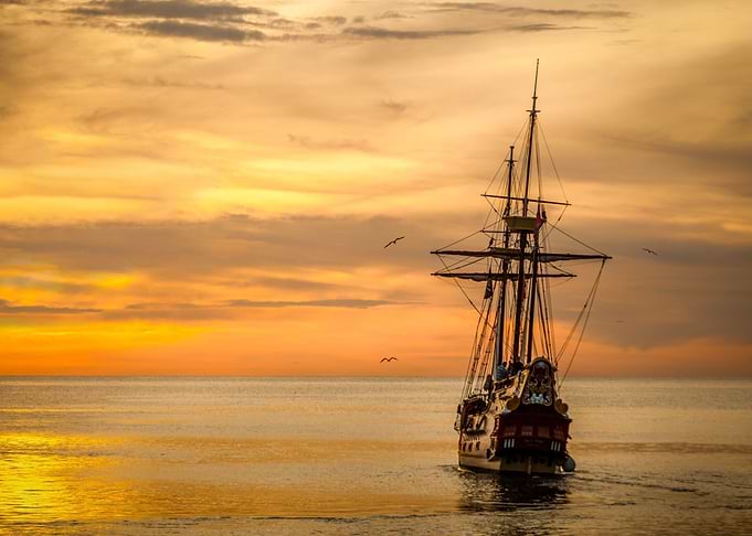 orange beach boat sunset