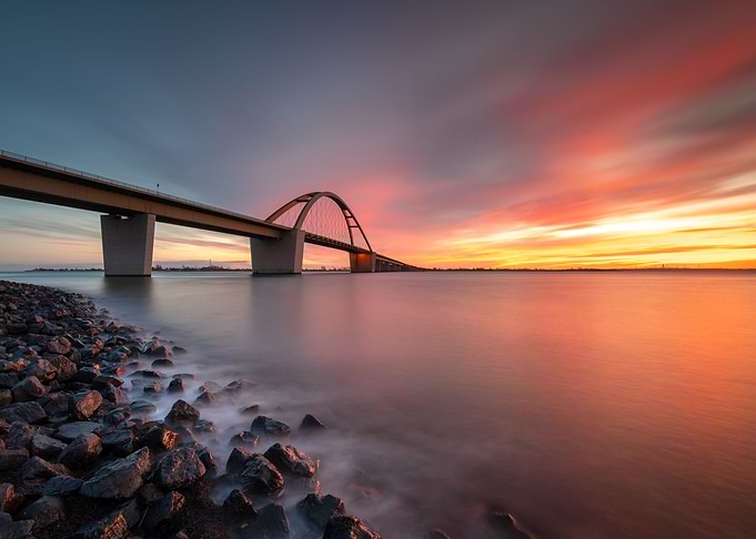 Bridge spans water sunset