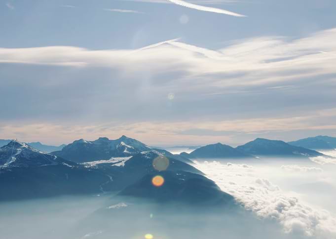 Mountain top clouds below