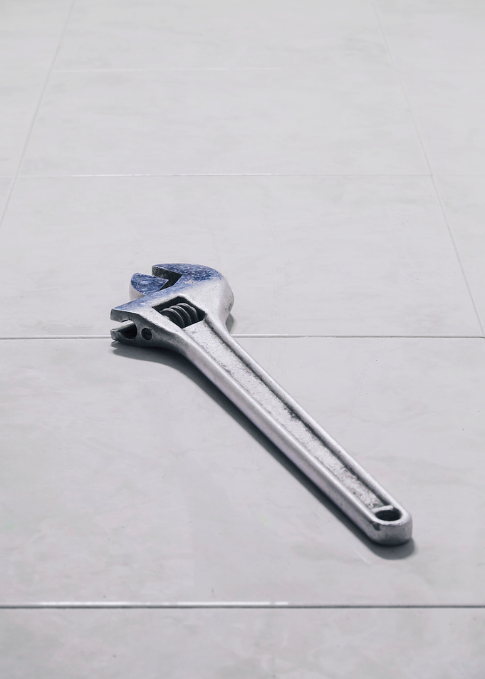 Wrench clean left on floor