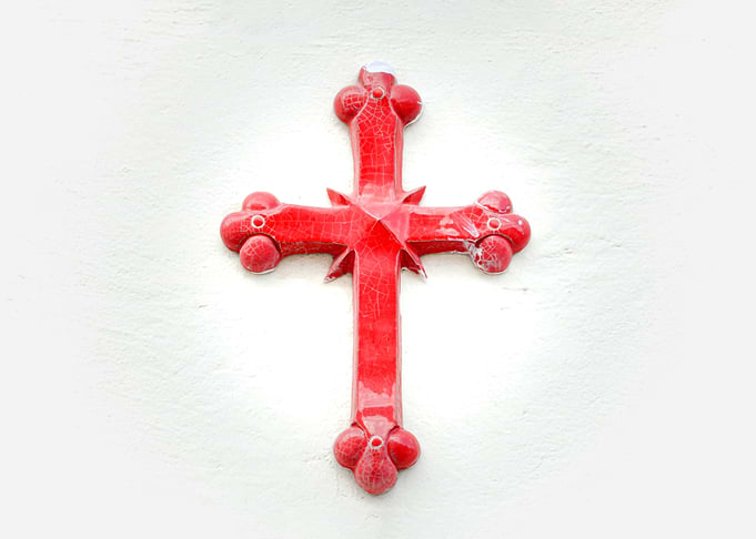 Cross red on wall bright