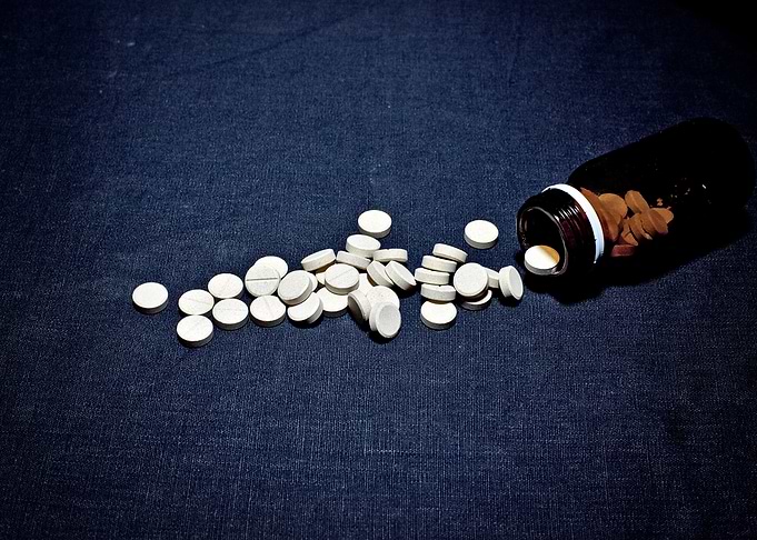 White pills glass bottle