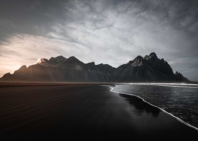 Black beach with mountains