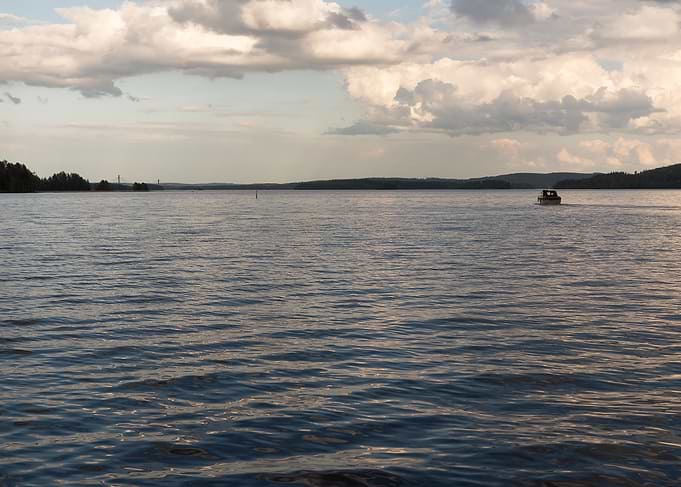 Boat Traveling To Horizon