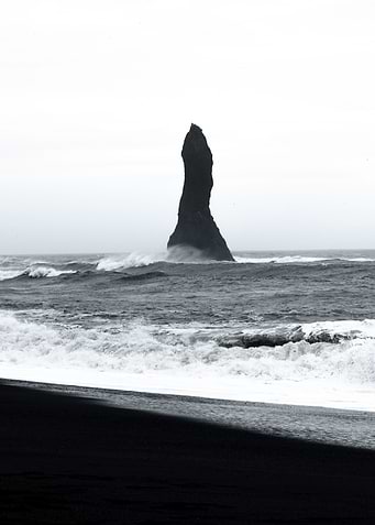 Rock on black beach