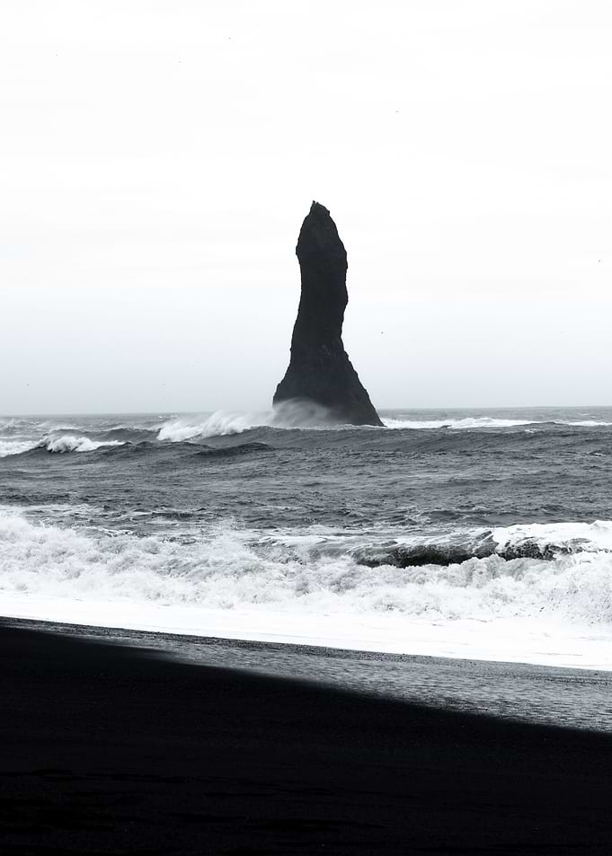 Rock on black beach