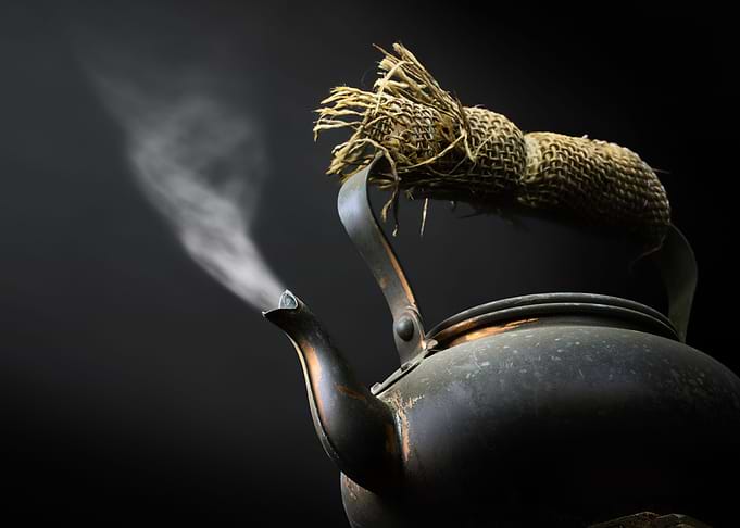 Black kettle with steam