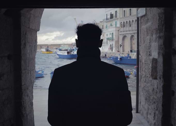 Man shadow sea port