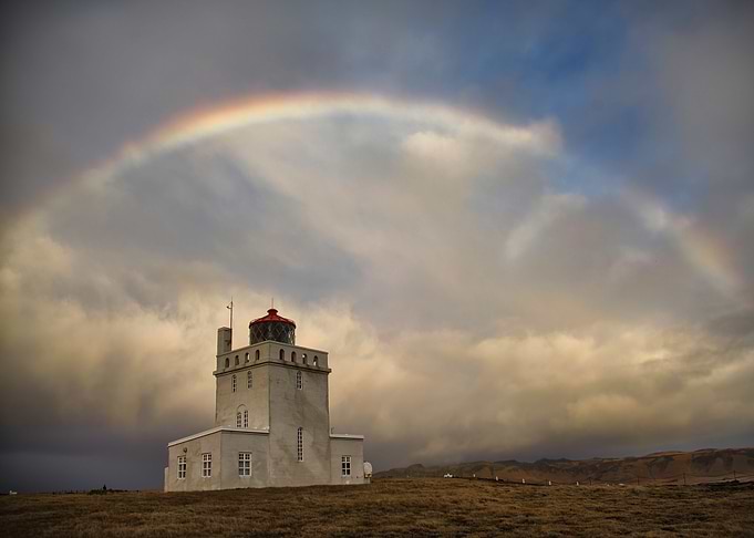 Lighthouse under rainbow