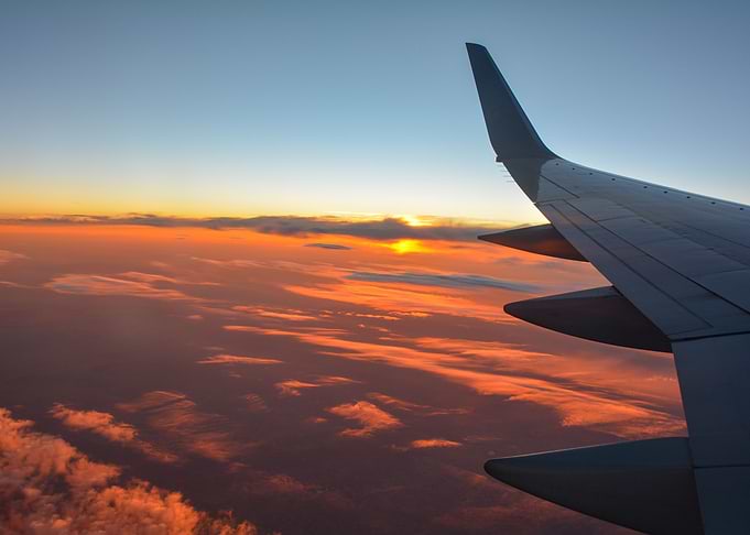 Airplane wing and sunset