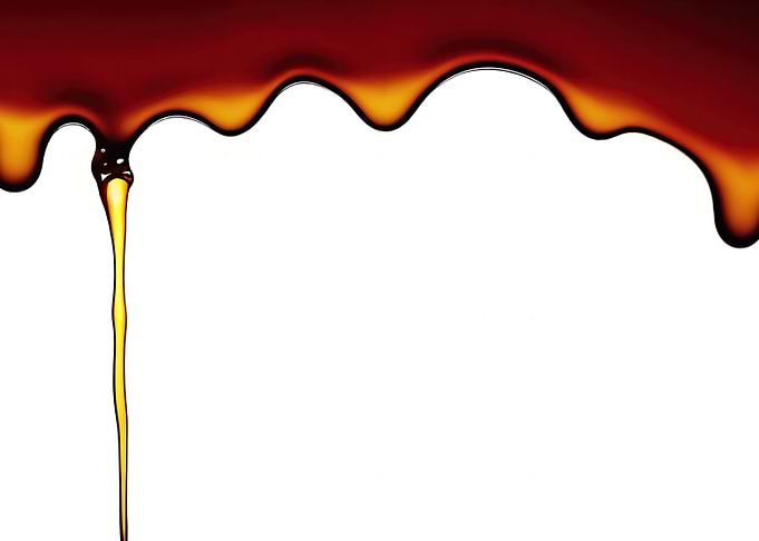 Honey dripping on white to