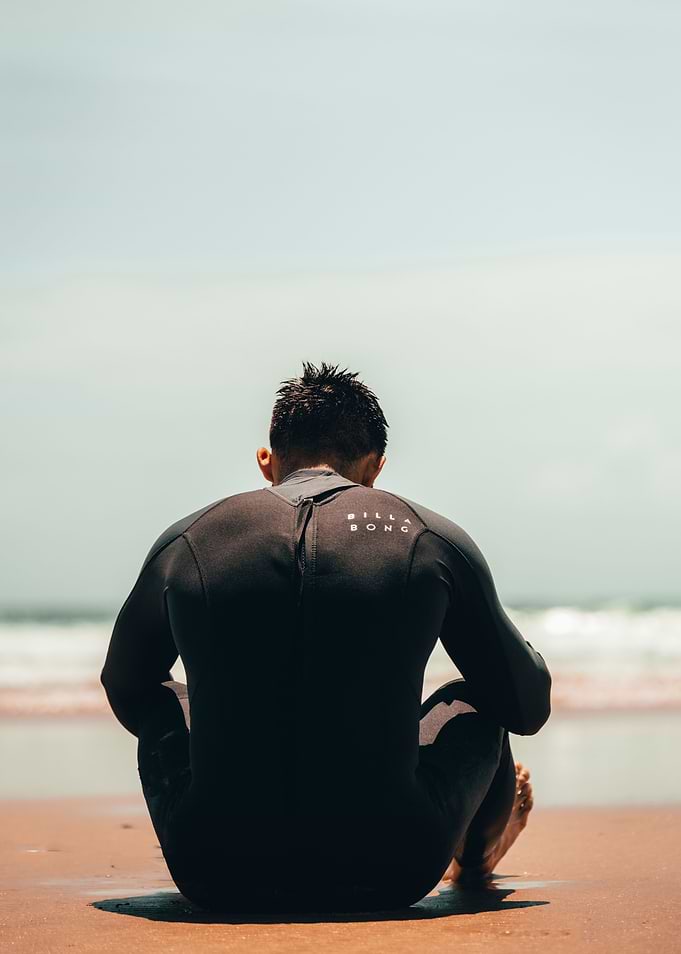 Surfer Resting on Beach