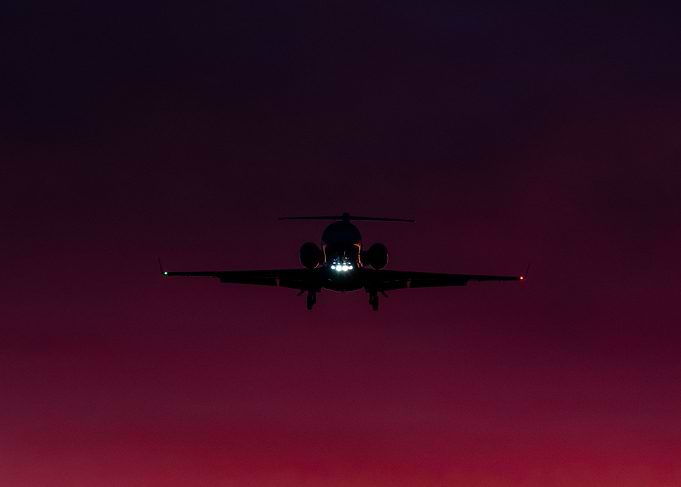 Private Jet on sunset sky