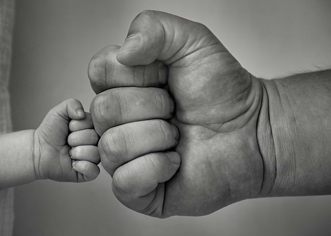 Hands of father and son