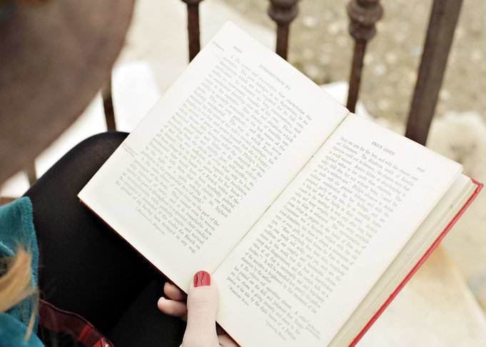 Romantic girl reading a bo