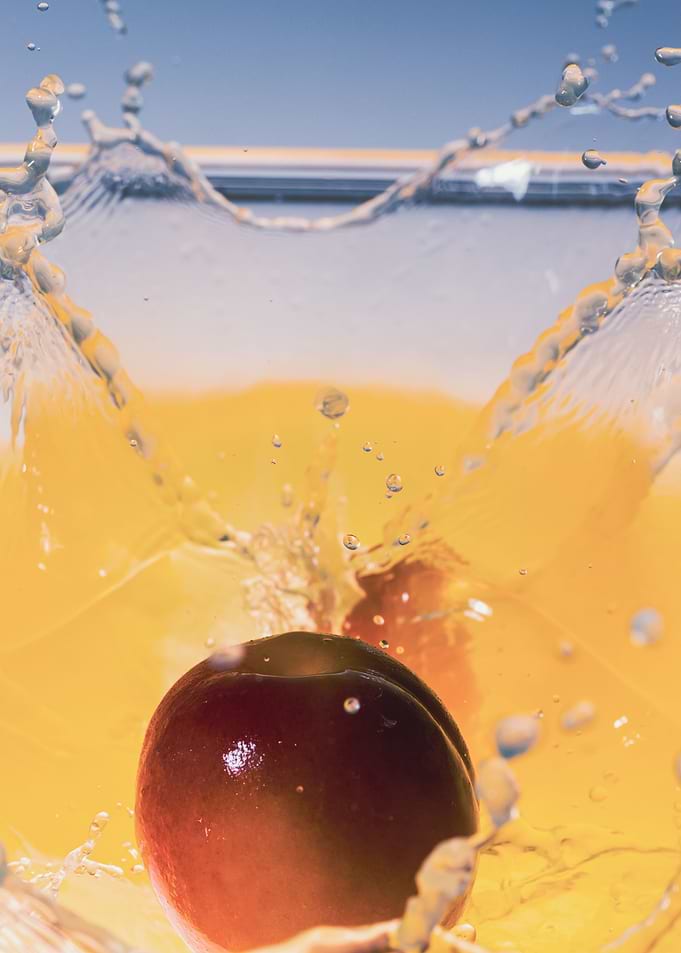 Apricot falling into juice