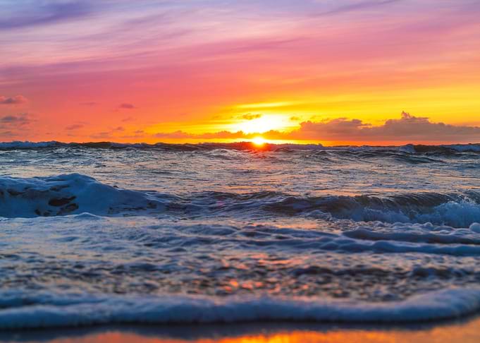 sun setting over ocean