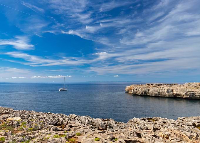 White sailboat in blue sea