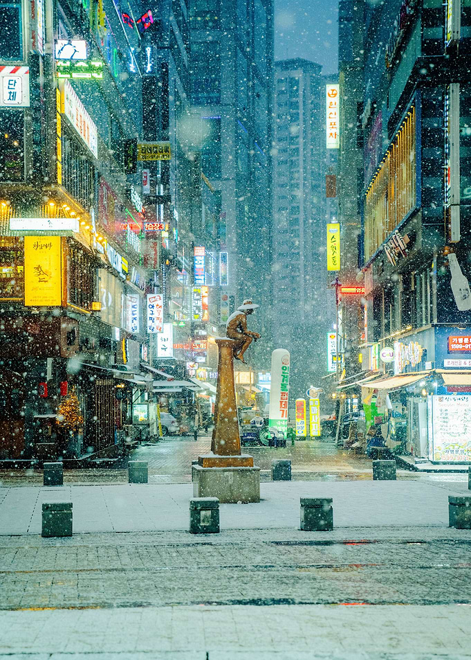 Statue in Snowy Neon Stree