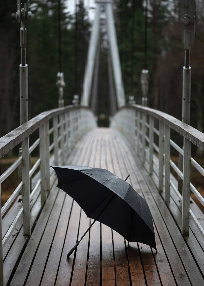 Umbrella on wooden bridge