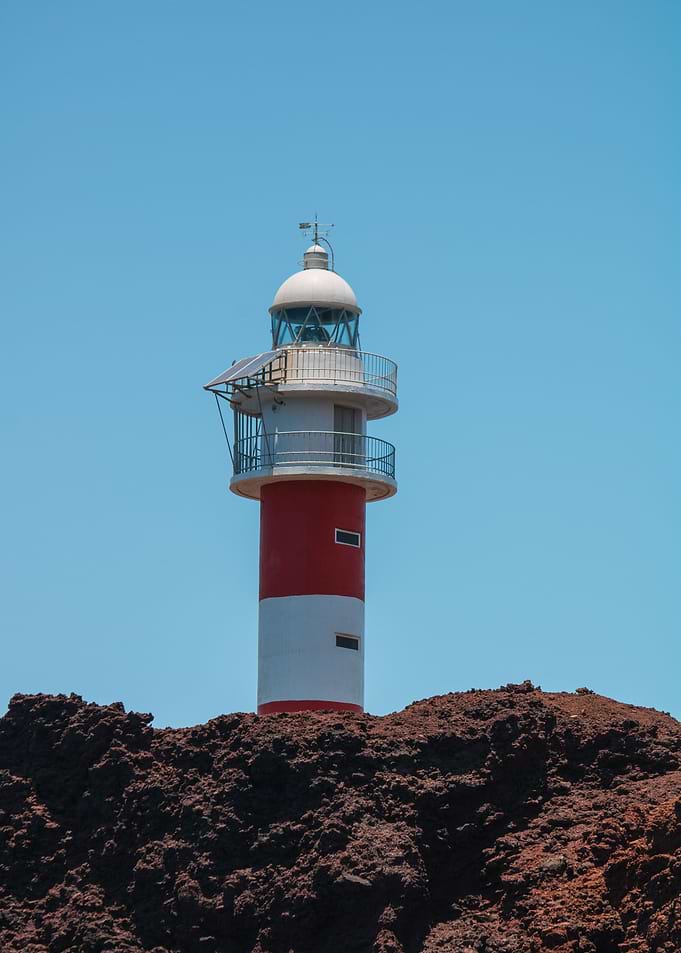 Lighthouse and Rocky Shore