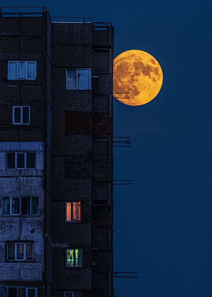 Moon against a building