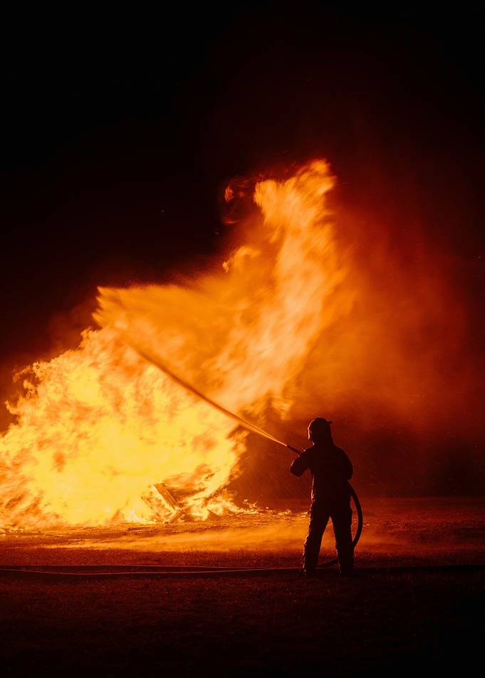 A man holding a fire hose