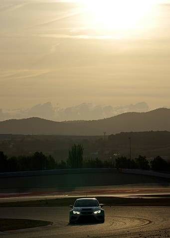 Race Car on Track at Sunset