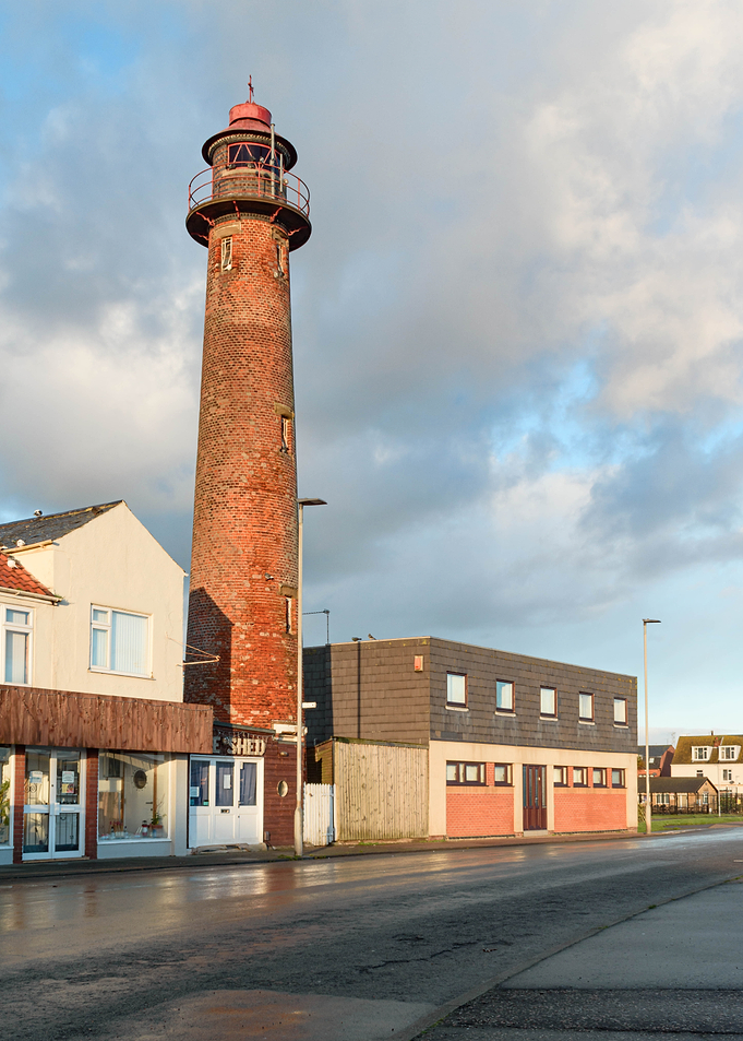 Brick Lighthouse on a Street