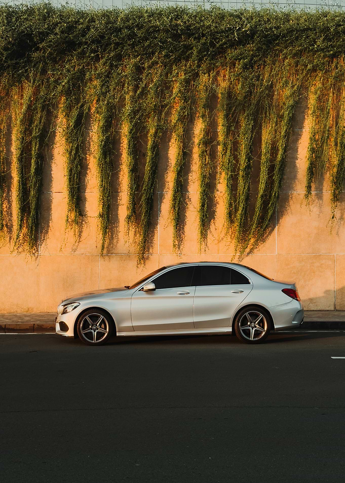 Silver Sedan Parked by Wall